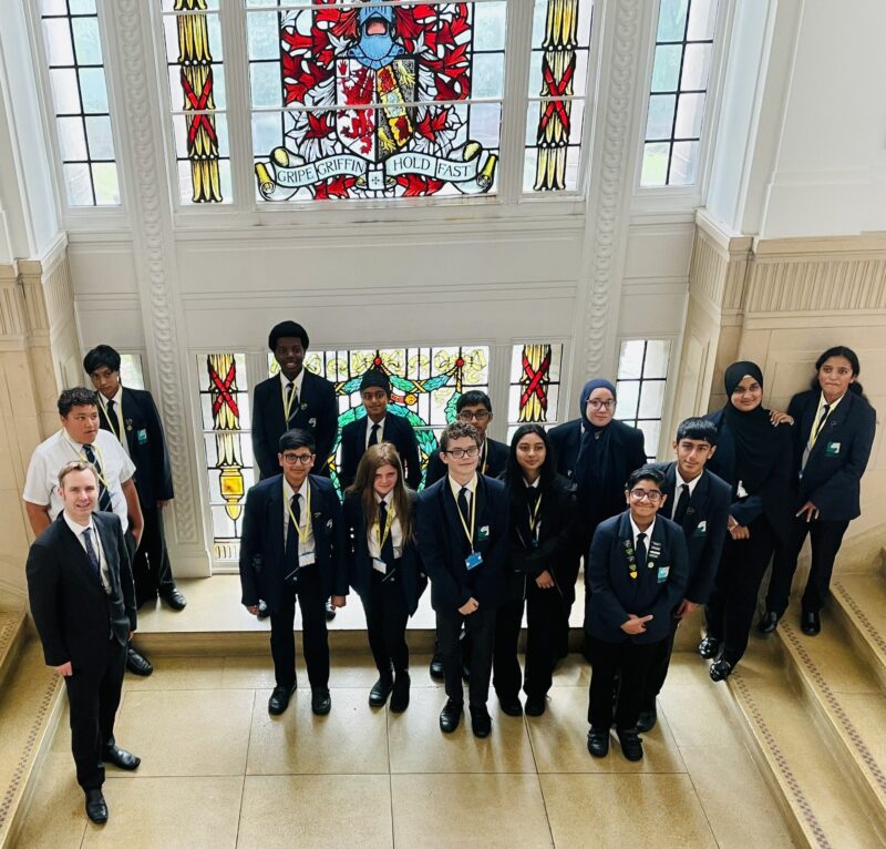 Council leader, Cllr Tom Ross pictured at Trafford Town Hall with Stretford High students.