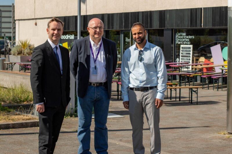 From left, Cllr Tom Ross pictured with Gareth Wilkins, retail manager at Stretford Mall and  postmaster is Arif Matadar.